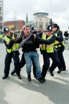 Protestor is grabbed by police after crossing the "Ring of Steel" fence in Barkers Pool, outside Sheffield city Hall where the Liberal Democrats are holding their Party conference Conference Sheffield Saturday
12 March 2011
Images © Paul David Drabble