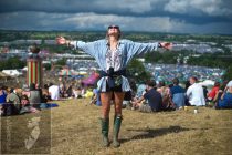 A festival-goer enjoys a moment of sunshine before the rain, on the hill overlooking the festival
Glastonbury Festival 2014
Worthy Farm, Pilton, Somerset, UK
© James McCauley