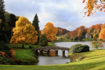 WARMINSTER, ENGLAND - NOVEMBER 03: The sun shines on trees that are displaying their autumn colours surrounding Palladian bridge and the lakeside Pantheon at the National Trust's Stourhead on November 3, 2010 near Warminster, England. The UK is currently enjoying one of the best autumn displays for years, due in part to the long drought of this year's spring, and the wet and cool of the late summer that followed. (Photo by Matt Cardy/Getty Images)