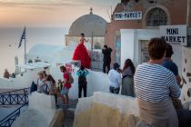 Bride poses for her personal photographer as part of a honeymoon photo shoot on the Greek island of Santorini. ©Neil Turner. 19 October 2015