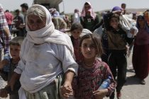 Displaced Yazidis pass through Faysh Kharbur in Iraqi Kurdistan on on August 9, 2014. Tens of thousands of Yazidis, members of an obscure Zoroastrianism religion, fled the town of Sinjar in northern Iraq after it was taken by Islamic militant fighters a week ago and have made their way on foot to here. Some hid out on Mt Sinjar, others walked to the Kurdish area of Syria.

Tens of thousands of refugees have passed here in the last six days. ISIS threatened them with death if they did not convert to Islam.  Currently many more Yazidis are sheltering on Mount Sinjar amid extremely harsh conditions.
[Sam Tarling/ The Telegraph]