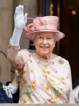 Queen Elizabeth II and Prince Philip, Duke of Edinburgh wave from the balcony of the Town Hall in Liverpool
