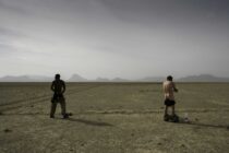 Two British soldiers take a moment to have a bottle wash on the desert plains west of Musa Qala during fighting to retake the Helmand province town from the Taliban. They were part of the British Reconnaissance Force (BRF) 52 Brigade were a specialist observation unit and mobile fighting force in Helmand province, Afghanistan used against the Taliban in late 2007 and early 2008. They lived and slept in the open air under the Helmand skies from their vehicles and wagons and rarely returned to base. They were resupplied by air or land convoys and reputedly were involved in the longest desert patrol by British forces since WWII. They were called the ‘Warriors whom God protects’ by the Taliban due to their lightly armoured and slightly ramshackle wagons. They could rarely wash or shave and were a fairly wild bunch to look at. On one of the few occasions they retired to Camp Bastion a senior British commander told them that they looked a disgrace and made them shave their beards off. The BRF had become supersicious and believed that this took some of their mystic and luck away and never forgave the Colonel concerned. In December 2007 they secured a safe route into Musa Qala to retake the town from the Taliban, probing their units and fighting against them as they tried to avoid the many I.E.D.s and countless legacy mines laid by the Russians during their time there in the 1980’s. As well as clearing the way for a 400 vehicle convoy they co-ordinated air support for U.S. Forces and provided fire support for them during the battle to drive the Taliban from the Helmand town. I spent two weeks with the B.R.F. living and sleeping under the stars on the Helmand plains.On the evening that we joined them by a re-supply convoy they had suffered the death of one of their comrades in an IED blast which also resulted in serious injury to two others. A few weeks after I left them I was added to hear that a young soldier called Cpl Darryl Gardiner was killed by an I.E.D. blast. He was the driver for the wagon which I lived in for the time I spent with them and had got to know him fairly well. He died after a Land Rover WIK was blown up by a legacy mine and as his vehicle was the Brigades company ambulance if needed he was killed as he took the survivors to a helicopter landing strip in the desert when his open vehicle struck an I.E.D. killing him and injuring the survivors from the first blast. Photograph:Philip Coburn