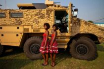 Two models stand in front of an Armoured Personnel Carrier at ShieldAfrica  Arms Fair 2017, the International Security and Defence Exhibition that took place in Abidjan, Côte d'Ivoire from the 24 to 26 January 2017.
Photo:Philip Coburn