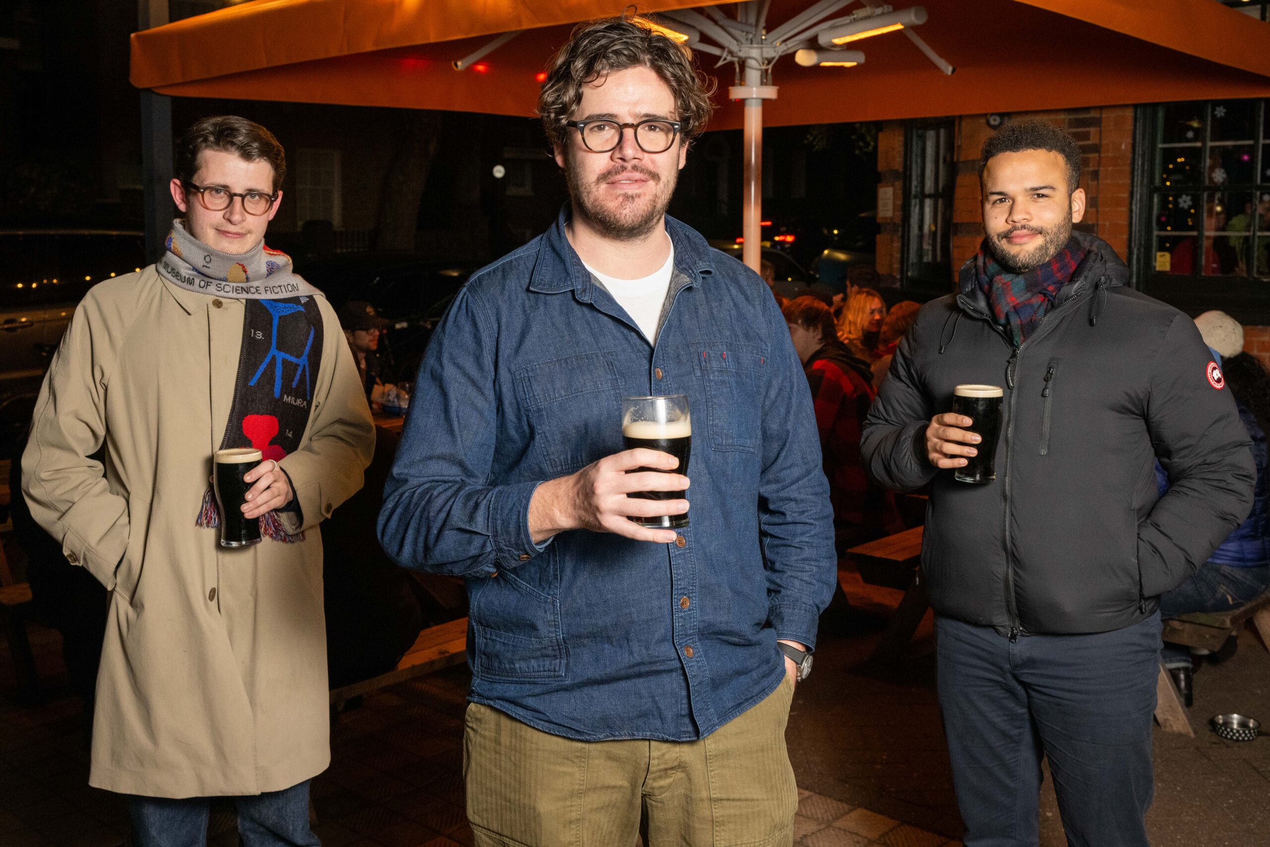 LONDON, ENGLAND - DECEMBER 29: (L-R) Charlie Cooke from the group "One Million Beers Please", Oscar Notley also from "One Million Beers Please" and Aidan Smith from "1 Million Beers" pose for a portrait outside of Grove House Tavern in Camberwell on December, 29, 2025 in London, England. Charlie Cooke and Aidan Smith are the founders of two separate groups competing to be the first to reach one million beers. Each participant, among hundreds of beer enthusiasts, contributes to the tally by submitting a photograph of their pint marked with the running total of beers consumed, all in pursuit of the shared end goal: one million beers.