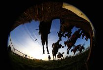 Horse Racing - Cheltenham Festival - Cheltenham Racecourse - 10/3/15
Horses clear a fence during 17.15 CHAPS Restaurants Barbados Novices' Handicap Chase
Reuters / Eddie Keogh
Livepic
EDITORIAL USE ONLY.