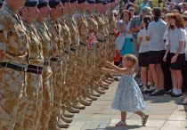 3 YEAR OLD BETHANY CARTER WAVES A FLAG AT HER FATHER CPL BRIAN CARTER DURNG THE 14TH SIGNAL REGIMENT PARADE IN HAVERFORDWEST