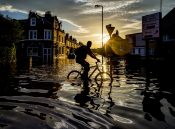 Bruce Adams - A cyclist travels through flood water along Warwick Road, Carlisle, after severe flooding across the county. December 7, 2015