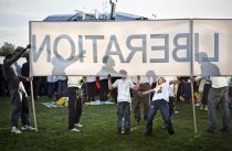Children play under a banner reading "Liberation" at Hyde Park mass on day 3 of Pope Bendict XVI's four day visit to the UK. It is the first time the head of the Catholic church has visited Britain since 1982.