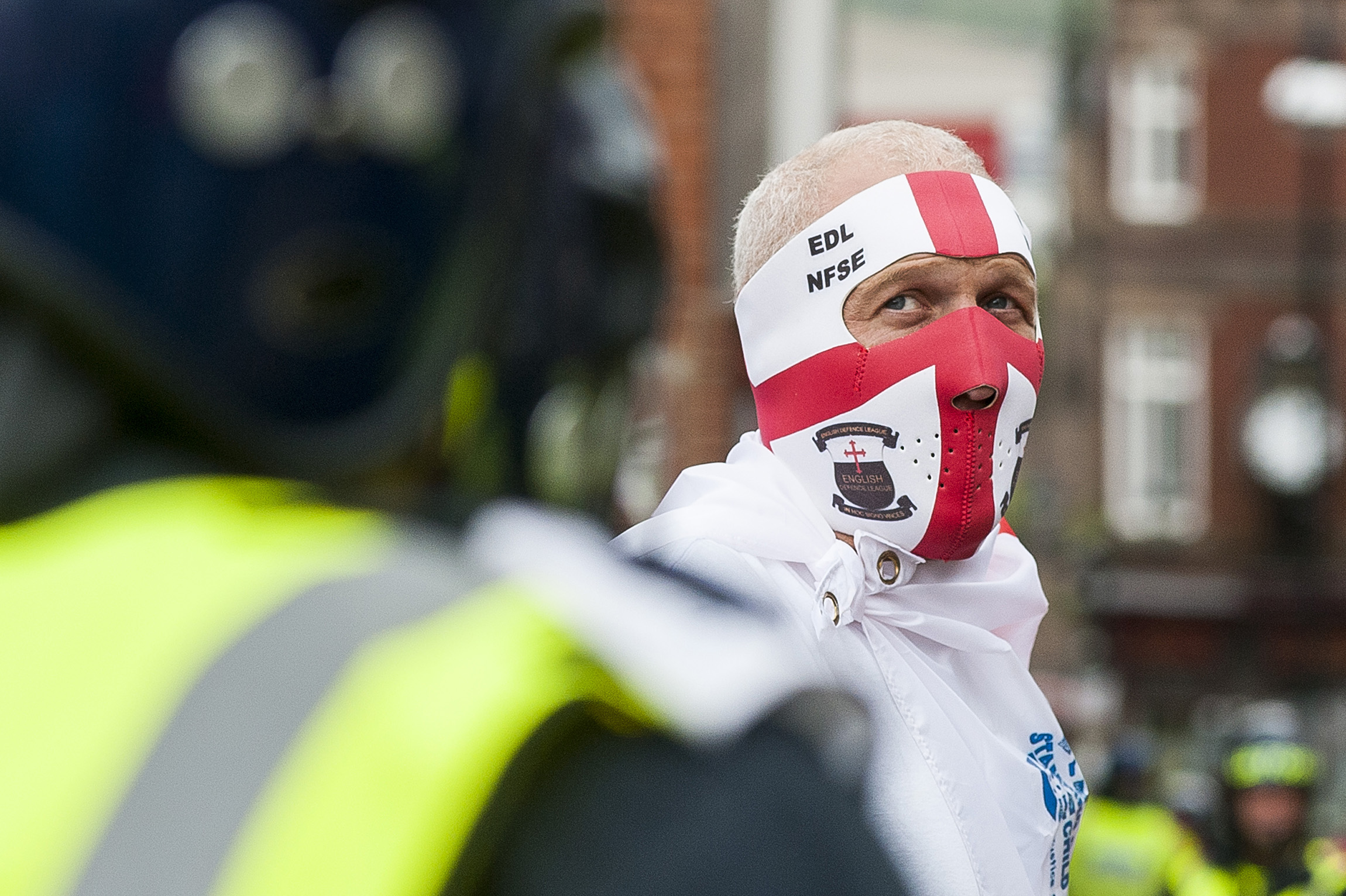 An EDL supporter and Police in full Riot kit on the streets close to Rotherham Town Hall shortly before the start of the English Defence Leagues "Justice for the Rotherham 1400" March on Saturday Afternoon which was described by an EDL Facebook Page as "a protest against the Pakistani Muslim grooming gangs"
Image © Paul David Drabble
www.pauldaviddrabble.co.uk