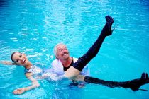 Virgin Atlantic is celebrating 25 years of flying between London and Miami with a "Miami Vice" themed photocall. Sir Richard Branson arrives by speedboat, whilst giving chase to supermodel Karolina Kurkova, eventually catching her and handcuffing her with gold cuffs, to a press conference announcing the launch of a new route between London and Cancun. Sir Richard Branson throws supermodel Karolina Kurkova into the hotel swimming pool. Mondrian Hotel, Miami Beach, Florida, USA. June 16, 2011. Photo: Edmond Terakopian