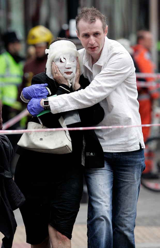 Paul Dadge (28) helps Davinia Turrell (age 24) to safety after emerging from Edgware Road Underground Station. A suicide bomber blew himself up on a tube train at the station, killing seven passengers. This was one of four terrorist attacks on the transport system, resulting in 52 innocent deaths. London, 7 July 2005.
Picture by: Edmond Terakopian