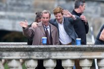 PIC BY GEOFF ROBINSON PHOTOGRAPHY 07976 880732.
Picture shows James Norton (right) and Robson Green waving to people on punts whilst filming the ITV drama Grantchester on Clare College Bridge in Cambridge on Monday September 7th.
After starring in the BBC's new raunchy adaptation of Lady Chatterley's Lover last night (Sun), heart throb James Norton was back filming today (Mon) as the vicar in the new series of Grantchester.
The 30-year-old, who played Lord Chatterley in a wheelchair in last night's programme, looked pleased to be back in his role as Sidney Chambers in the ITV detective series.
He was seen walking along the picturesque Backs in the city of Cambridge as he chatted to actor Robson Green, who plays Detective Inspector Geordie Keating.
At one point the pair were seen drinking coffee inbetween takes and waving to fans on the riverside.
The River Cam, which runs behind the historic Cambridge University colleges, was transformed to look like the 1950's, with punt loads of people in costume.
Norton, who studied theology at Cambridge University and knows the city well, looked happy and relaxed as he played the country vicar, who helps fight crime in his small community.
SEE COPY CATCHLINE James Norton on river filming