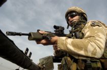 British soldiers from The East and West Riding Regiment, Territorial Army wearing desert camouflage, Kevlar helmet and body armor, carrying SA80 assault rifle which is fitted with SUSAT sights, Travel in convoy in "Soft Skin" Land Rovers with troops manning the top cover position. The convoy is moving from Basra Air Station to Shibah Logistics Base during Op-Telic in March 2005