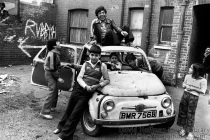 Children play with an abandoned car in Fieldgate Mansions, Whitechapel. Scheduled for demolition in 1972 it was squatted by homeless people, artists & Bengali immigrants preventing destruction until taken over by a community housing trust in 1980 & modernised.
© David Hoffman phone +44 (0)20 8981 5041, fax +44 (0)20 8980 2041, email lib@hoffmanphotos.com  
NUJ & BAPLA recommended terms & conditions apply. Moral rights asserted under Copyright Designs & Patents Act 1988.
Full terms and conditions for digital and traditional use available on request. Credit is required. No part of this photo to be stored, reproduced, manipulated or transmitted by any means without permission.