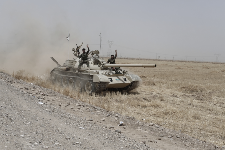 Kurdish Peshmerga drive a tank that was abandoned by the Iraqi army toward Kirkuk in Northern Iraq, near the current front line between ISIS and Kurdish forces near the town of Hwaija, on June 12, 2014.
[Sam tarling for the Telegraph]