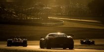 Cars drive at dawn during the Le Mans 24 Hour sportscar race in Le Mans.