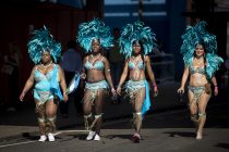 © London News Pictures. 26/08/2012. London, UK. Revelers and carnival-goers arriving to take part in day two of the Notting Hill Carnival in West London on August 26, 2013.  The annual carnival, which is the largest of its kind in Europe, is expected to attract around 1 million people. Photo credit : Ben Cawthra/LNP