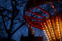 © London News Pictures. 25/05/2014. Pat deconstructing the Chair-o-planes ride at night at Battersea Park in South London. This series of images documents the colourful people that work tirelessly all year round maintaining the history of the steam fair, which is struggling to survive in the face of rising costs, council charges and other hardships. For almost 40 years family run Carterís Steam Fair, based near Maidenhead in Berkshire, has travelled the spring and summer months around the UK offering a glimpse of steam powered history to the public. Most of their work goes unseen in the winter months working to maintain and restore the rides to full glory while back at the yard.  Carters showcases rides dating back almost 120 years, with the centre piece ride, The Gallopers, dating back to 1895. All of the rides are carefully hand painted and can take days to construct.  **COPY AVAILABLE HERE** - https://tinyurl.com/nm687ma   Photo credit : Ben Cawthra/LNP