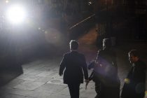 Hugh Grant (centre) lit by photographers flashes as he leaves The Royal Courts of Justice today after giving evidence to the Leveson Inquiry into press standards.