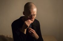 Hermit Sister Rachel Dentontakes off her cross as she prepares herself for her bed at St Cuthberts' Hermitage in Lincolnshire, north east Britain September 25, 2015. Sister Rachel Denton has vowed to spend the rest of her life living as a consecrated hermit in the Catholic faith. A hermit is a person who chooses to live alone, with the intention of finding God. Rarely leaving her house she lives a life of prayer and solitude. However, she uses the internet and social media to share her experience and distance her self from physically interacting with society. REUTERS/Neil Hall