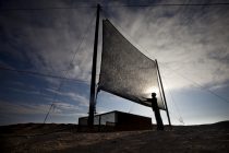 25 March 2013 Credit: Neil Hall
Feature: Fog Catchers of the Atacama
Image of a fog collecting net at the Alto Patache fog oasis near Iquique in northern Chile. When fog passes through the net water condenses into small drops before being collected into a a water tank.
The Atacama desert in Northern Chile is the driest place in the world. In many places rainfall has never been recorded and there is no possibility of life. However, people are trying to reverse the trend of desertification by harvesting coastal fog in large nets. Fog and moisture in the air passes through the net and condenses before travelling through pipes into tanks where it is stored.
The fog water is pure for drinking and can be used for agriculture. The Universidad Catolica has a scientific research centre at Alto Patache. The results have shown that life is waiting to be found in the desert. Fog water has been used to transform a once arid patches of desert into a gardens. Currently a collective in the village of Chanaral use the water for Aloe Vera farming.
Water is a vital resource in the Atacama where it is scarce and in high demand from mining industries. Currently water is piped to towns from hundreds of miles away in the Andes or driven by water trucks. Fog collection offers a clean cheap and sustainable water resource for the future. However, in Northern Chile it is in danger unless there is further investment from the government and authorities.
