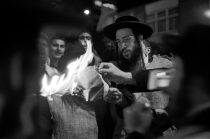 A member of the Orthodox Neutrei Karta sets light to an Isreali Flag whilst protesting outside a Zionist Federation Conference...