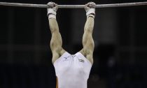 Epke Zonderland of the Netherlands performs on the horizontal bar in the men's artistic qualification round during the International Gymnastics competition in east London January 10, 2012. The competition is the second and final chance for gymnasts to qualify for the London 2012 Olympic Games. REUTERS/Eddie Keogh (BRITAIN - Tags: SPORT GYMNASTICS TPX IMAGES OF THE DAY) - RTR2W3HJ