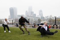 London Mayor Boris Johnson takes part in a tug of war with members of the armed services to launch the London Poppy Day, outside City Hall, in London, October 27, 2015. London Poppy Day is a street collection event to raise money for serving and retired members of the armed services and their families. REUTERS/Stefan Wermuth TPX IMAGES OF THE DAY - RTX1TFDB