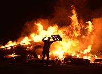 Residents in Ratho in West Edinburgh add to the unofficial bonfire in the village. Despite official bonfire night events being banned due to the covid pandemic communities throughout Scotland continued with the annual tradition.
(c) Dave Johnston