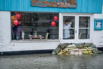 14 Feb 2014 Waves & Flooding hit Looe.  The chef at The Trawlers on the quay keeps an eye on the water level.