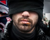Jungle, Calais, France. 02 March, 2016. One of a group of desperate Iranian refugees to sew up their mouths in order to signify that their voices are not being heard by the French authorities demolishing the Calais Jungle camp in Northern France.