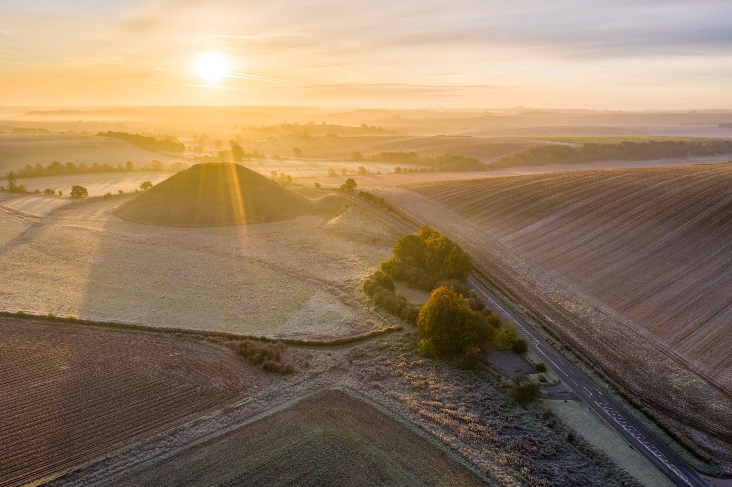 Silbury Hill, Nr Avebury, Wiltshire, UK. 28th October 2019. Drone image of a frosty red morning sky above the ancient man-made mound of Silbury Hill.  Lee Thomas. Tel. 07784142973. Email: leepthomas@gmail.com www.leept.co.uk (0000635435)
