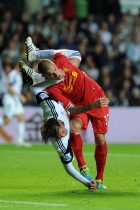 Swansea city's Michu ©gets tangled up with Liverpool's Martin Skrtel after going for a header. Barclays Premier league match, Swansea city v Liverpool at the Liberty Stadium in Swansea, South Wales on Monday 16th Sept 2013. pic by Andrew Orchard, Andrew Orchard sports photography,