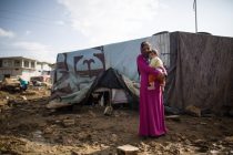 Wahak, 13, carries her 6-month old brother Khaled in a makeshift tented community in Lebanon's Bekaa valley that has become home to some 150 families who have fled the conflict in neighboring Syria. Wahak arrived here with her family 6 months ago. The families here live with little protection from the elements in homes made of plastic sheeting and scavenged materials, such as burlap sacks and old billboard banners. Despite the cold already setting in, many of the children still lack proper winter clothes and footwear to adequately protect them from the cold. Nov 21 2012 [Sam Tarling]
Picture taken on 18 July, 2013.
